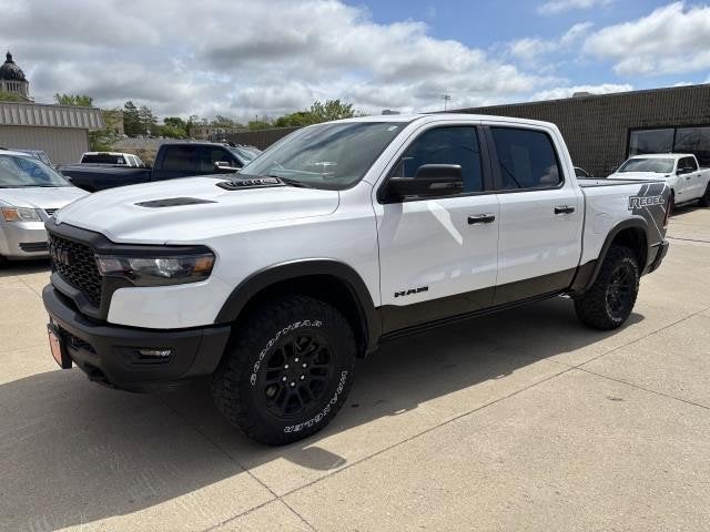 2025 RAM 1500 Rebel Crew Cab 4x4 5'7' Box in Bright White Clearcoat — front three-quarter view